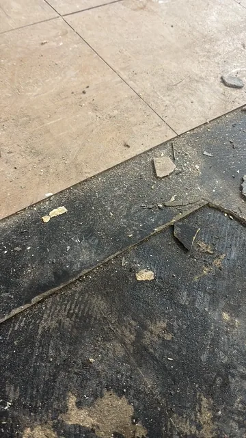 Black bitumen mastic floor removal in a SE1 flat